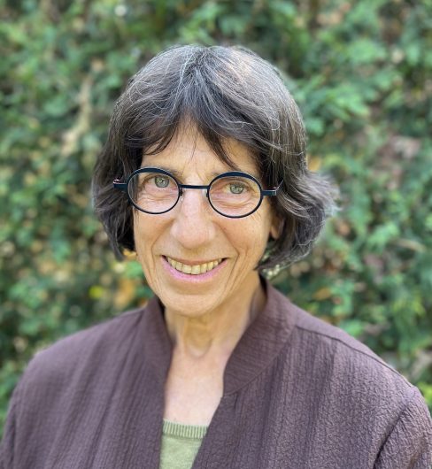 Anne Schmitz in front of some trees.