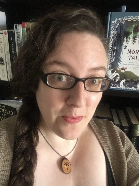 Marie Victoria Robertson sitting in front of a bookcase.